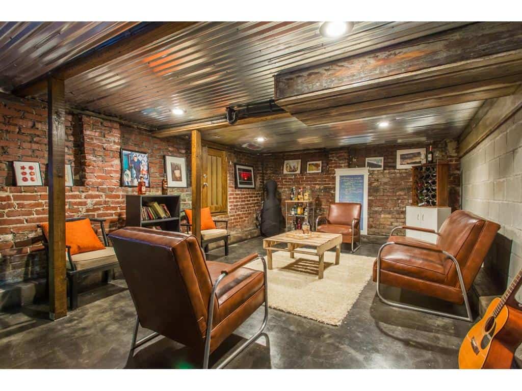 Perfect Man Cave with tin ceiling, exposed brick in this Atlanta Old Fourth Ward Bungalow